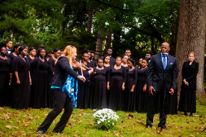 Vocalist Keith Spencer, right, and violinist Claudia Pellegrini, left, perform at a memorial service for the forgotten slaves buried on the grounds of Middletown Friends Meeting at Langhorne, Pa. on Saturday, Oct. 6, 2018. (Brad Larrison for WHYY)