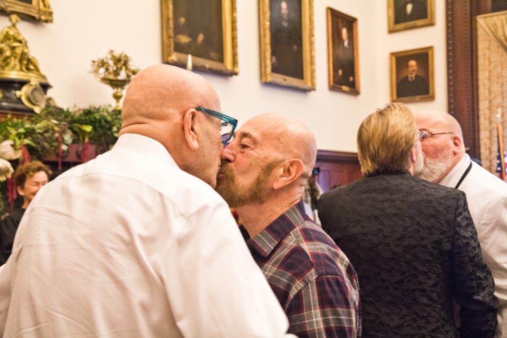 2018 10 11 k paynter national coming out day vows-9 Charles Massucci kisses his partner of 47 years, Joseph DiDio, as they renew their vows at the National Coming Out Day event at City Hall Thursday. (Kimberly Paynter/WHYY)