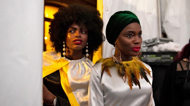 Models line up before taking to the runway at Philadelphia Fashion Week, held at Dilworth Park. (Kriston Jae Bethel for WHYY)