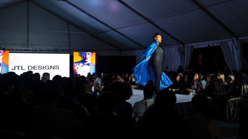 A model is met with cheers as she takes the runway at Philadelphia Fashion Week, held at Dilworth Park. (Kriston Jae Bethel for WHYY)