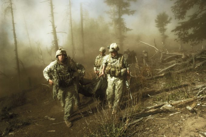 US troops carry the body of Staff Sergeant Larry Rougle, who was killed when Talibaninsurgents ambushed their squad in the Korengal Valley, Afghanistan, October 2007.