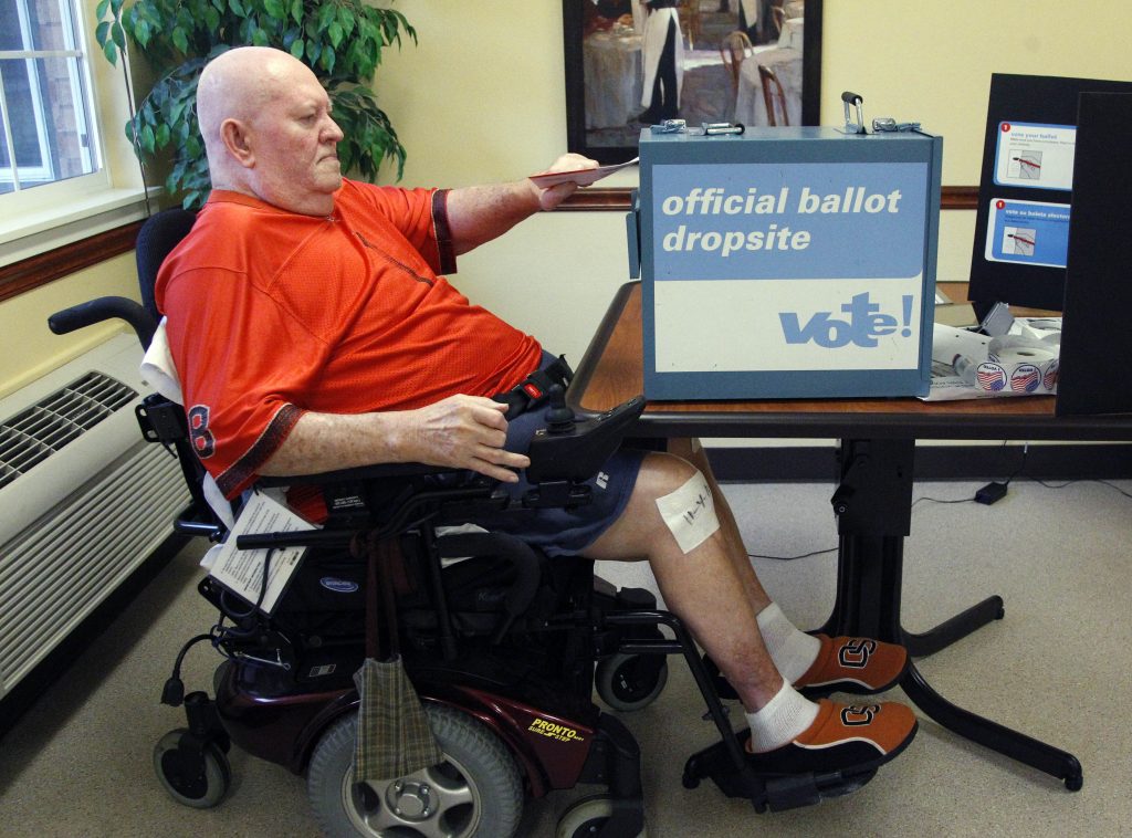 Vote By iPad Lewis Crew, 75, casts his ballot in Beaverton, Oregon. A Tuesday forum organized by the University of Delaware's Center for Disabilities Studies addressed the barriers that keep many of those with disabilities from voting. (AP Photo/Rick Bowmer)