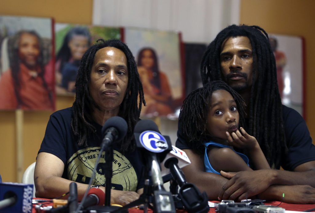Debbie Africa, Michael Africa Jr., Alia Africa Debbie Africa, (left), participates in a news conference alongside her son Michael Africa, Jr. and granddaughter Alia, 6, Tuesday June 19, 2018, in Philadelphia. Africa, a member of the radical group MOVE, was released from prison on Saturday, nearly 40 years after the group engaged in a shootout that killed a Philadelphia police officer in 1978. Michael Africa, Sr., has now also been released. (Jacqueline Larma/AP Photo)