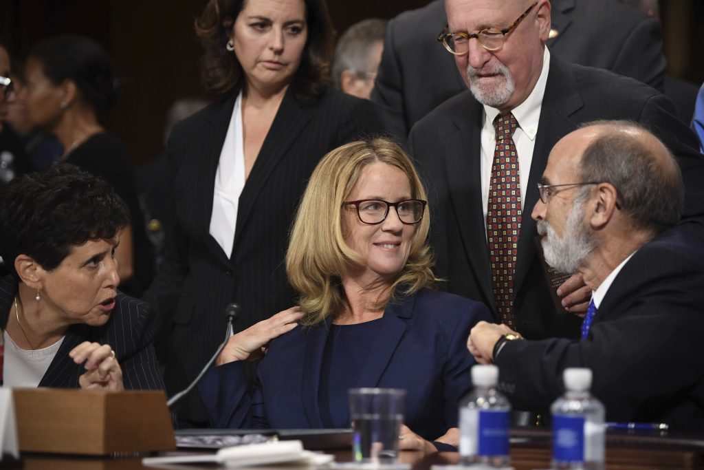 Supreme Court Kavanaugh Christine Blasey Ford, the woman accusing Supreme Court nominee Brett Kavanaugh of sexually assaulting her at a party 36 years ago, chats with her attorneys as she testifies before the US Senate Judiciary Committee on Capitol Hill in Washington, DC, September 27, 2018. (Saul Loeb/Pool Photo via AP)