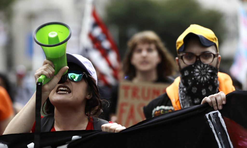 Trump Demonstrators protest before a speech by President Donald Trump at the National Electrical Contractors Convention, Tuesday, Oct. 2, 2018, in Philadelphia. (AP Photo/Matt Slocum)