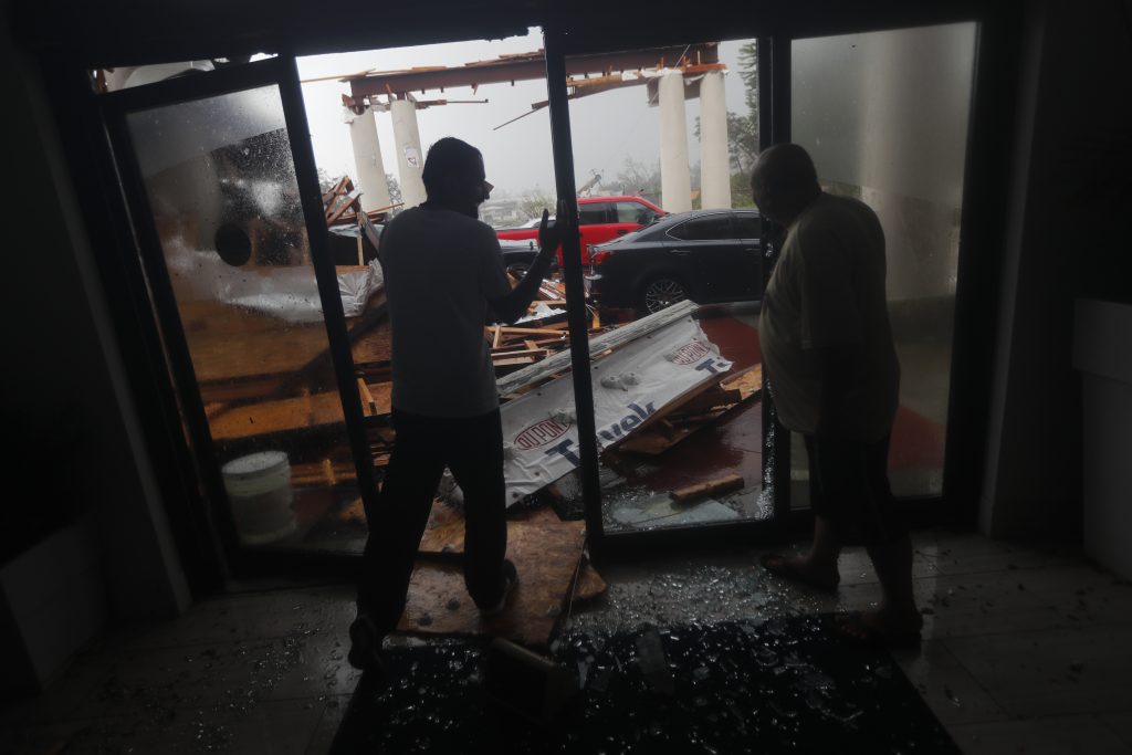 Tropical Weather Florida Hotel employees look at a canopy that just collapsed, as Hurricane Michael passes through in Panama City Beach, Fla., Wednesday, Oct. 10, 2018. (AP Photo/Gerald Herbert)