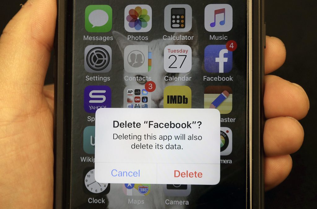 Zombie Accounts What to Do In this March 27, 2018, file photo, a reporter holds a phone showing the Facebook app in San Francisco. It might not seem like a big deal to have long-forgotten accounts on social media linger. But with hacking in the news constantly, including a breach affecting 50 million Facebook accounts, you might not want all that data sitting around. (Jeff Chiu/AP Photo, File)