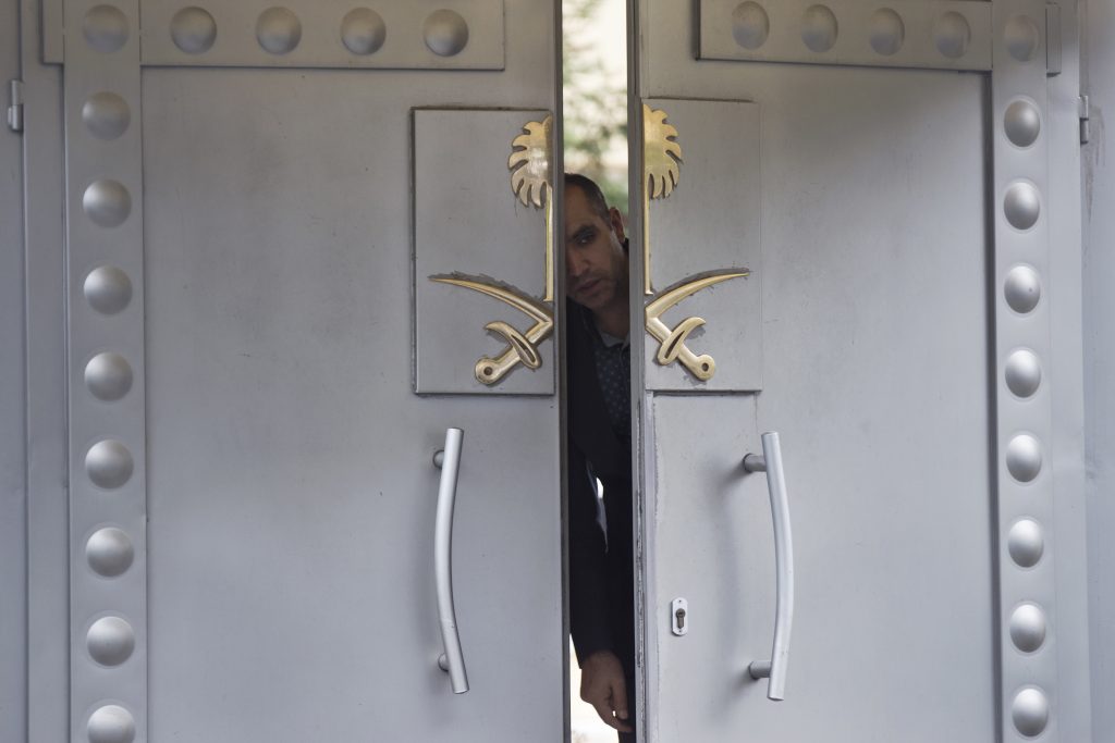 Turkey Saudi Arabia Missing Writer A security personnel looks out from the entrance of the Saudi Arabia's consulate in Istanbul, Sunday, Oct. 14, 2018. Writer Jamal Khashoggi, vanished after he walked into the consulate on Oct. 2. (AP Photo/Petros Giannakouris)
