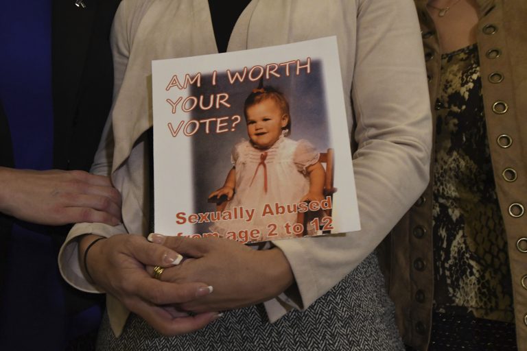 AP_18290797394237-768×512 Carolyn Fortney, a survivor of sexual abuse at the hands of her family's Roman Catholic parish priest as a child, awaits legislation in the Pennsylvania Capitol to respond to a landmark state grand jury report on child sexual abuse in the Catholic Church, Wednesday, Oct. 17, 2018 in Harrisburg, Pa. (Marc Levy/AP Photo)