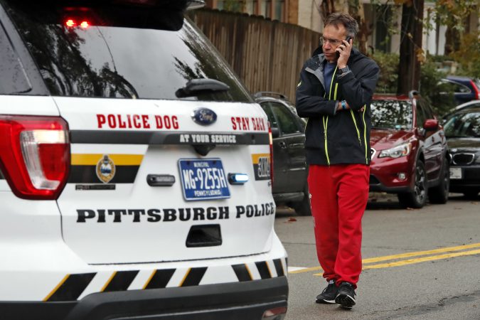 Michael Eisenberg, immediate past president of the Tree of Life Synagogue, talks to a reporter on the phone a few blocks from the Tree of Life Synagogue where a shooter opened fire Saturday, Oct. 27, 2018, injuring multiple people, including three police officers. (Gene J. Puskar/AP Photo)