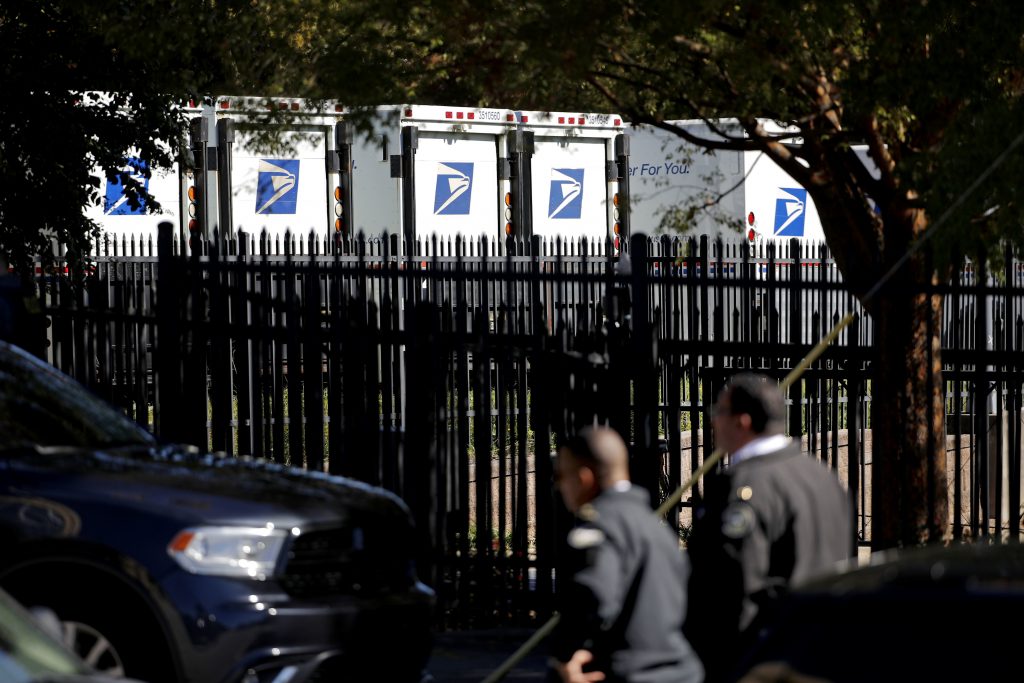 Explosive Devices Law enforcement officials gather outside a U.S. post office facility after reports that a suspicious package was found in Atlanta, Monday, Oct. 29, 2018. (AP Photo/David Goldman)