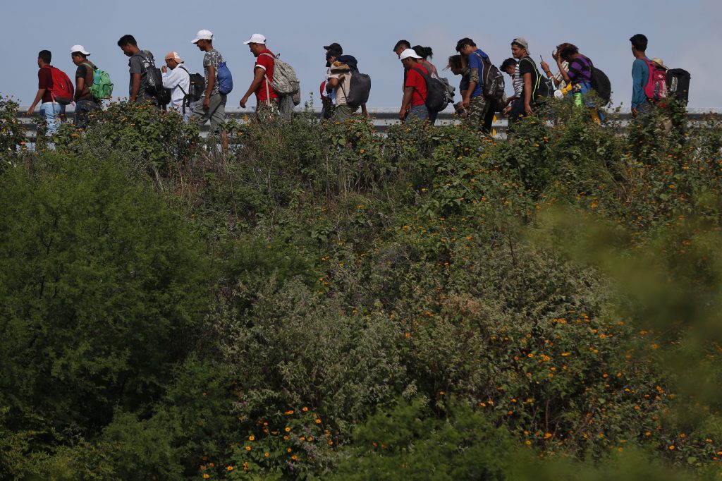 Central America Migrant Caravan Migrants walk along the highway as part of a thousands-strong caravan of Central Americans continuing its slow journey toward the U.S. border, between Niltepec and Juchitan, Oaxaca state, Mexico, Tuesday, Oct. 30, 2018. (Rebecca Blackwell/AP Photo)