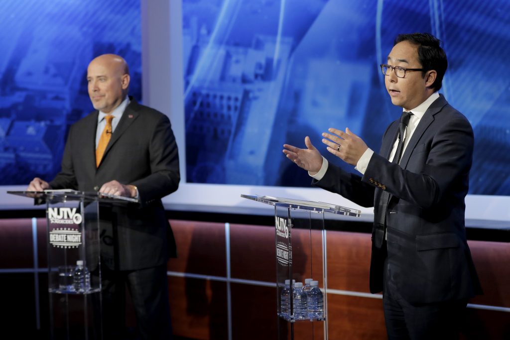 Andy Kim, right, the Democratic candidate in the U.S. Congressional District 3 race, speaks during a debate with Republican candidate Tom MacArthur, Wednesday, Oct. 31, 2018, in Newark, N.J. (AP Photo/Julio Cortez)