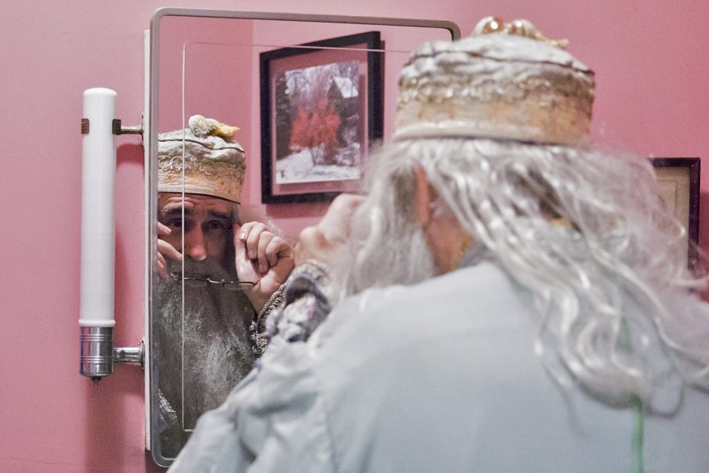 Dumbledore 08 Walt Maguire adjusts his glasses in his bathroom mirror on October 20, 2017. Maguire, 60, played the part of Dumbledore at Chestnut Hill’s Harry Potter Festival for six years. Now, he is co-hosting the Witches and Wizards festival costume contest. (Rachel Wisniewski for WHYY)