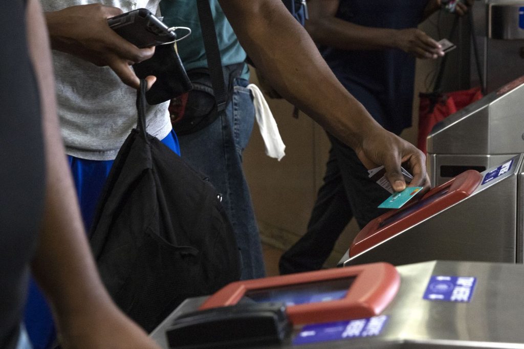 HXB2ERNSVJH6VNRSFNKSYW2D2I Commuters swipe their SEPTA key cards at the 69th Street Transportation Center in Upper Darby. (HEATHER KHALIFA / INQUIRER STAFF PHOTOGRAPHER)