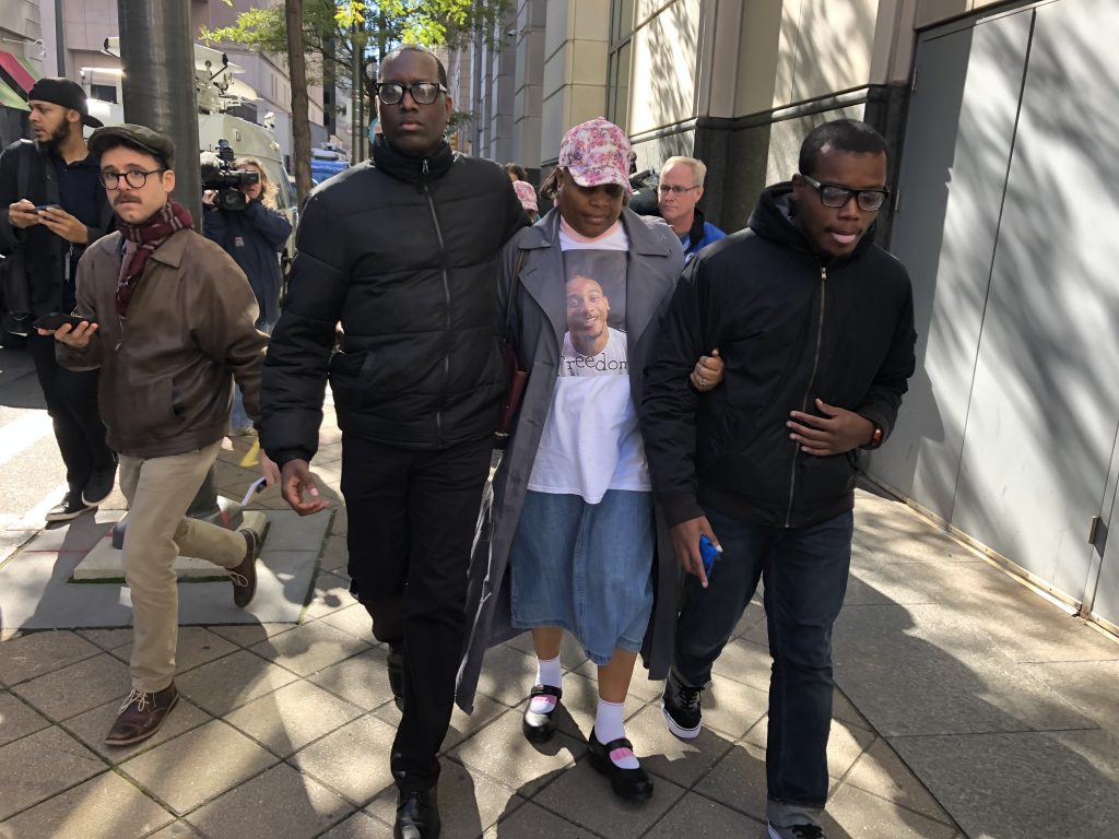 IMG_4892 Michael White’s aunt leaves the Philadelphia courthouse Tuesday with activist Asa Khalif and family. Her nephew is facing third-degree murder charges in the stabbing death of Sean Schellenger in July. (Bobby Allyn/WHYY)