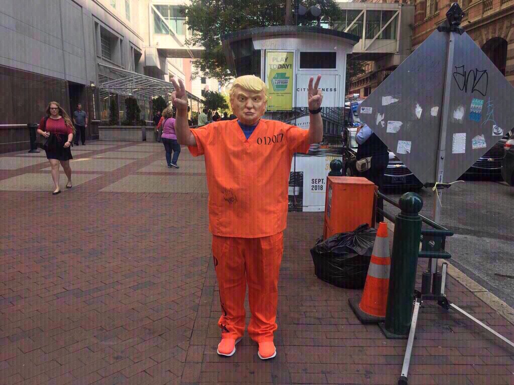 trump protest unique ratcliff Protester dressed as Trump in a prison uniform