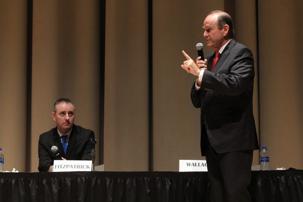 Image uploaded from iOS (44) U.S. Rep. Brian Fitzpatrick, a Republican, listens to his Democratic challenger in Pennsylvania’s 1st Congressional District, Scott Wallace, during a debate at Delaware Valley University in Doylestown. (Emma Lee/WHYY)
