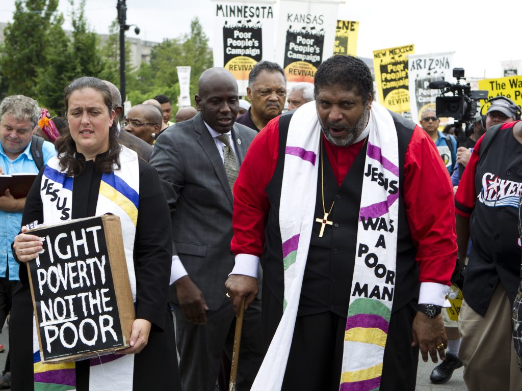 The Rev. William Barber marches outside the U.S. Capitol during a Poor People’s Campaign rally in June. On the left is co-leader of the Poor People’s Campaign, the Rev. Liz Theoharis. The Rev. William Barber marches outside the U.S. Capitol during a Poor People's Campaign rally in June. On the left is co-leader of the Poor People's Campaign, the Rev. Liz Theoharis. (Jose Luis Magana/AP)