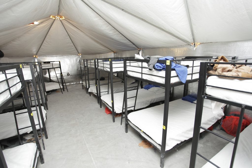 Just outside the tiny town of Tornillo, Texas, is a temporary shelter for migrant children. It opened in June and last month the federal government announced it was expanding the shelter's capacity to 3,800 beds — making it the largest shelter in the system for kids who cross the border alone. (U.S. Department of Health and Human Services via AP) 
