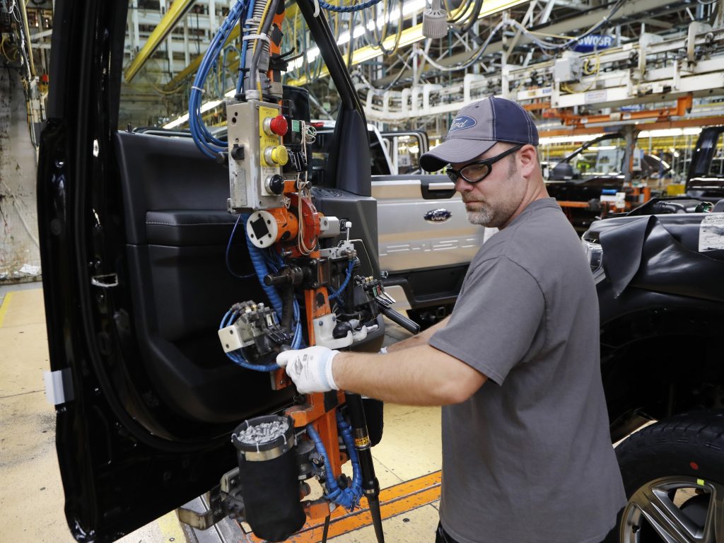 A worker installs a door on a 2018 Ford F-150 truck at an assembly plant in Dearborn, Mich., on Sept. 27. The U.S. unemployment rate fell to 3.7 percent in September, a nearly 50-year low. A worker installs a door on a 2018 Ford F-150 truck at an assembly plant in Dearborn, Mich., on Sept. 27. The U.S. unemployment rate fell to 3.7 percent in September, a nearly 50-year low. (Carlos Osorio/AP)