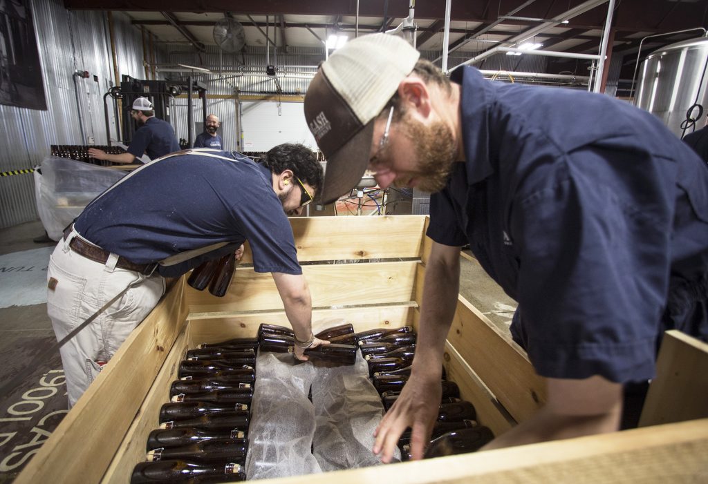Allagash employees Salim Raal, left, and Brendan McKay stack bottles of Golden Brett, a limited release beer fermented with a house strain of Brettanomyces yeast. The Maine brewery recently installed solar panels as part of its sustainability initiatives. Allagash employees Salim Raal, left, and Brendan McKay stack bottles of Golden Brett, a limited release beer fermented with a house strain of Brettanomyces yeast. The Maine brewery recently installed solar panels as part of its sustainability initiatives. (Derek Davis/Portland Press Herald via Getty Images)