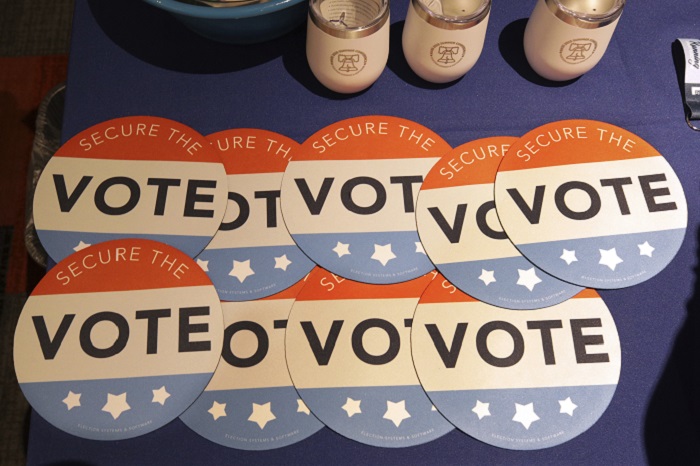 Election Security FILE - In this July 14, 2018, file photo, computer mouse pads with Secure the Vote logo on them are seen on a vendor's table at a convention of state secretaries of state in Philadelphia. As alarms blare about Russian interference in U.S. elections, the Trump administration is facing criticism that it has no clear national strategy to protect the country during the upcoming midterms and beyond. Both Republicans and Democrats have criticized the administration’s response as fragmented, without enough coordination across federal agencies. (AP Photo/Mel Evans, File)