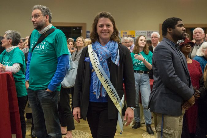 Bonny Hodges, a Delco Democrats  committeewoman for Springfield, shows how she votes on her sash at the official watch party for Mary Gay Scanlon in Swarthmore, Pa. on November 6, 2018. (Emily Cohen for WHYY)