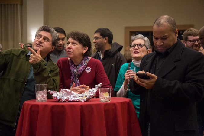 Rich Margulies (left) discusses the election results as they come in with his wife Deborah. Hundreds of supporters came out to support various Pennsylvania Democratic candidates at the official watch party for Mary Gay Scanlon in Swarthmore, Pa. on November 6, 2018. (Emily Cohen for WHYY)