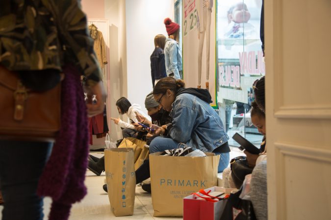 Shoppers take a break from shopping on Black Friday at the King of Prussia Mall in Pennsylvania November 23rd 2018. (Emily Cohen for WHYY)