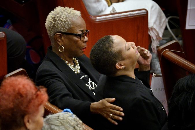 Dorothy Johnson-Speight, founder and executive director of Mothers in Charge, comforts a member of the group during a service at Enon Tabernacle Baptist Church. (Bastiaan Slabbers for Keystone Crossroads)
