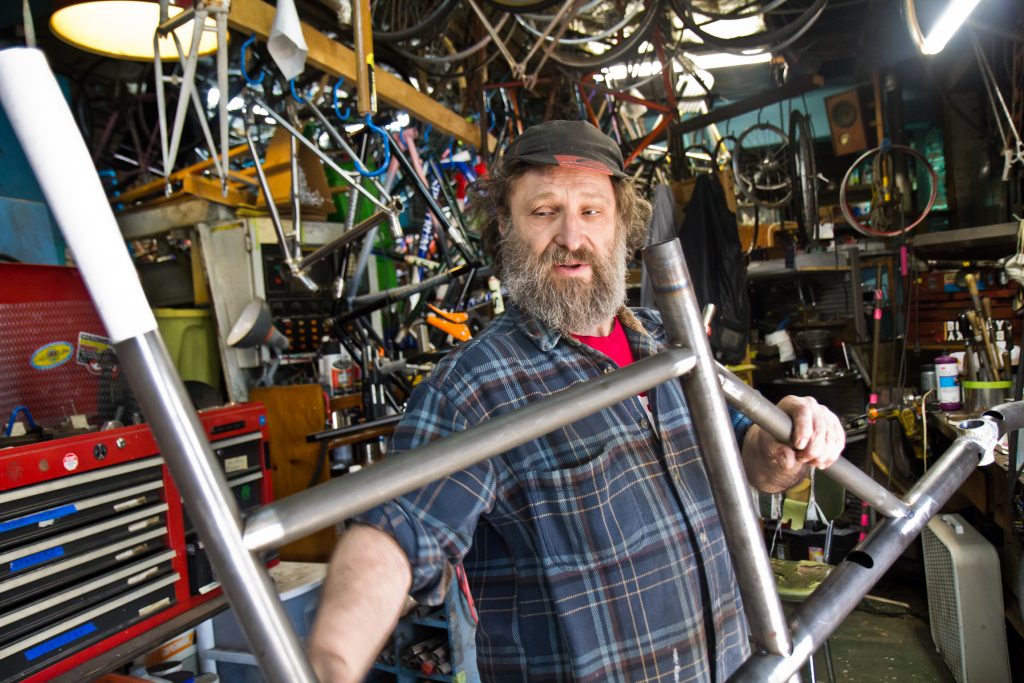 2018 10 25 k paynter bilenky cycle works-2 Stephen Bilenky holds a steel bike frame at Bilenky Cycle Works in Philadelphia. (Kimberly Paynter/WHYY)
