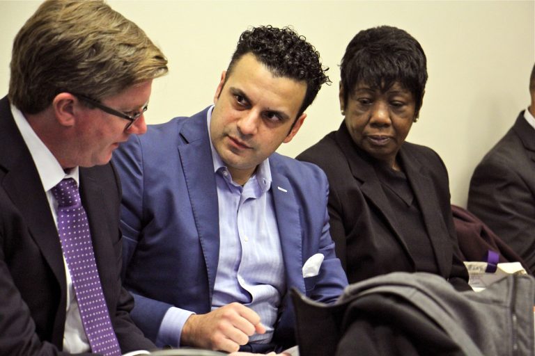 Developer Rahil Raza and Vivian VanStory consult with attorney Paul J. Toner during a Philadelphia zoning board meeting. (Emma Lee/WHYY)