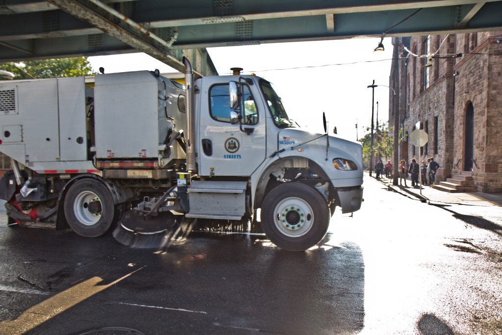 A mechanical street sweeper works along Kensington Ave. (Kimberly Paynter/WHYY) A street sweeper works along Kensington Avenue
