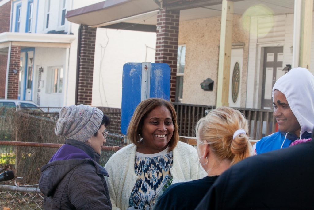 Connie Mella and her son Elvis were greeted by Tacony residents who came to show support for the family on Saturday after they received racist and threatening mail earlier this month. (Brad Larrison for WHYY)