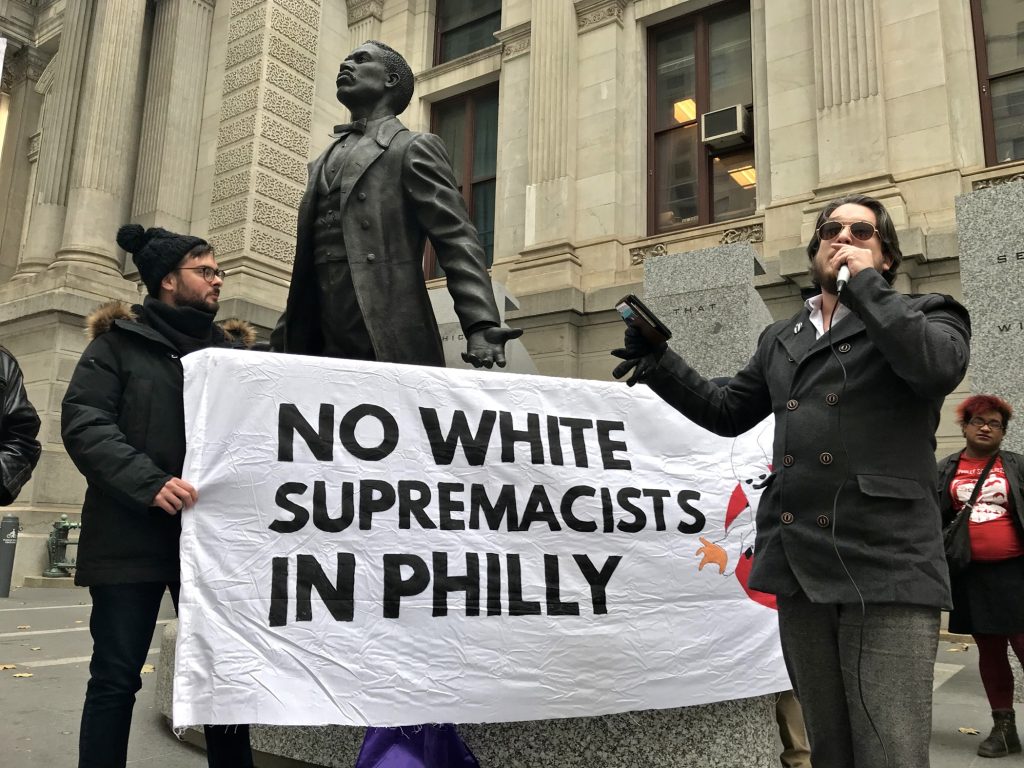 2018 11 14-l benshoff-philadelphia city hall-protest protest Ted Kelly of the Workers World Party (right) leads a protest against the We The People rally planned for Saturday on Independence Mall.