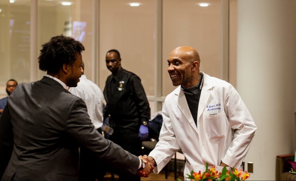 2018 11 15- b larrison- philadelphia- an evening with black men in medicine event at temple university -2 Anesthesiologist Kevin Guynn M.D greets a pre-med student at Temple University's An Evening with Black Men in Medicine event. (Brad Larrison for WHYY)