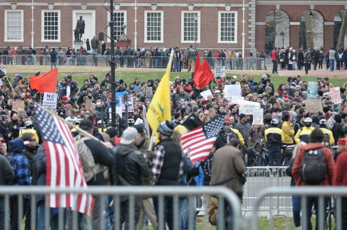 Counter-protesters in the background outnumber a small contingent gathered in the foreground during the 