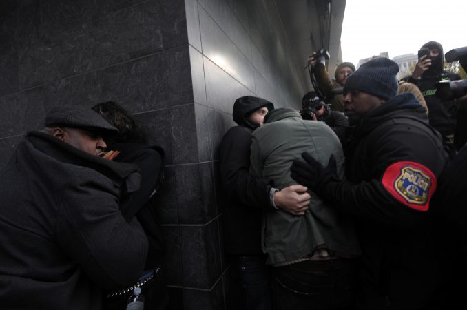One the left one counter-protesters is taken away by police after attacking an unidentified male, during the 