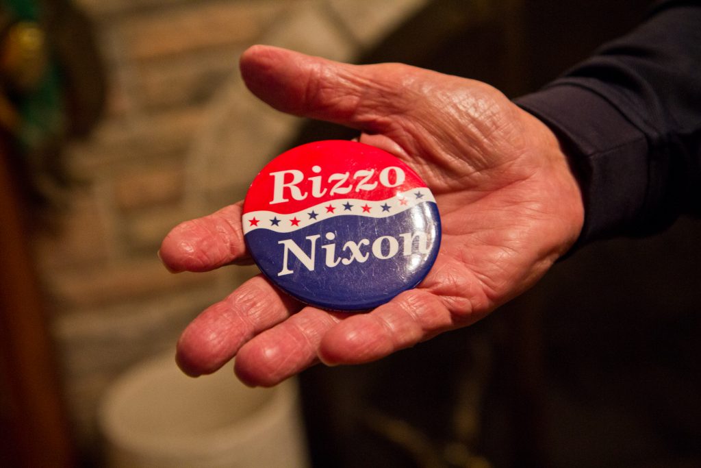 2018 11 19 rizzo estate-10 Frank Rizzo Jr. holds a campaign button with the Nixon/Rizzo ticket. (Kimberly Paynter/WHYY)