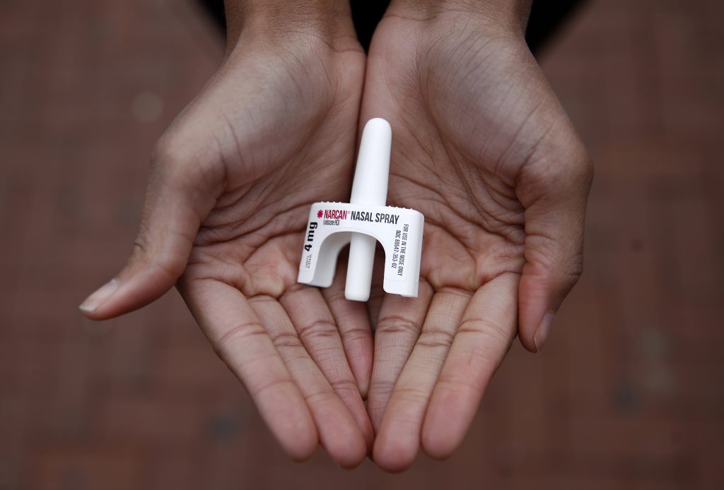 Narcan nasal spray held in open palms