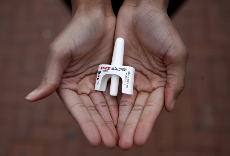 Narcan nasal spray held in open palms