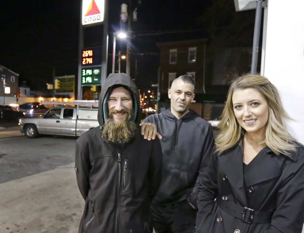 Helpful Homeless Man Johnny Bobbitt Jr., (left), Kate McClure, and Mark D'Amico pose at a gas station