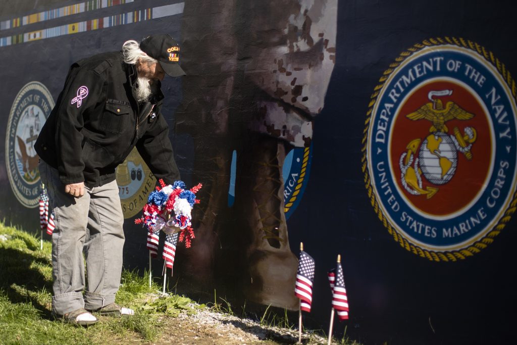 Pennsylvania Daily Life Veteran Patrick Watson places a wreath at the base of a new Mural Arts Philadelphia piece titled
