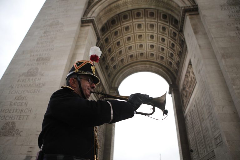 Military officer Garcia plays the original Armistice bugle from 1918 under the Arc de Triomphe Sunday, Nov. 11, 2018 in Paris. More than 60 heads of state and government are in France for the Armistice ceremonies at the Tomb of the Unknown Soldier in Paris on the 11th hour of the 11th day of the 11th month, exactly a century after the armistice. (AP Photo/Francois Mori, Pool)