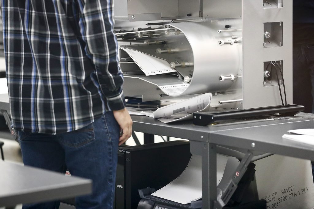 Elections staff prepare the machines for a recount at the Broward County Supervisor of Elections office on Sunday, Nov. 11, 2018, in Lauderhill, Fla. (AP Photo/Brynn Anderson)