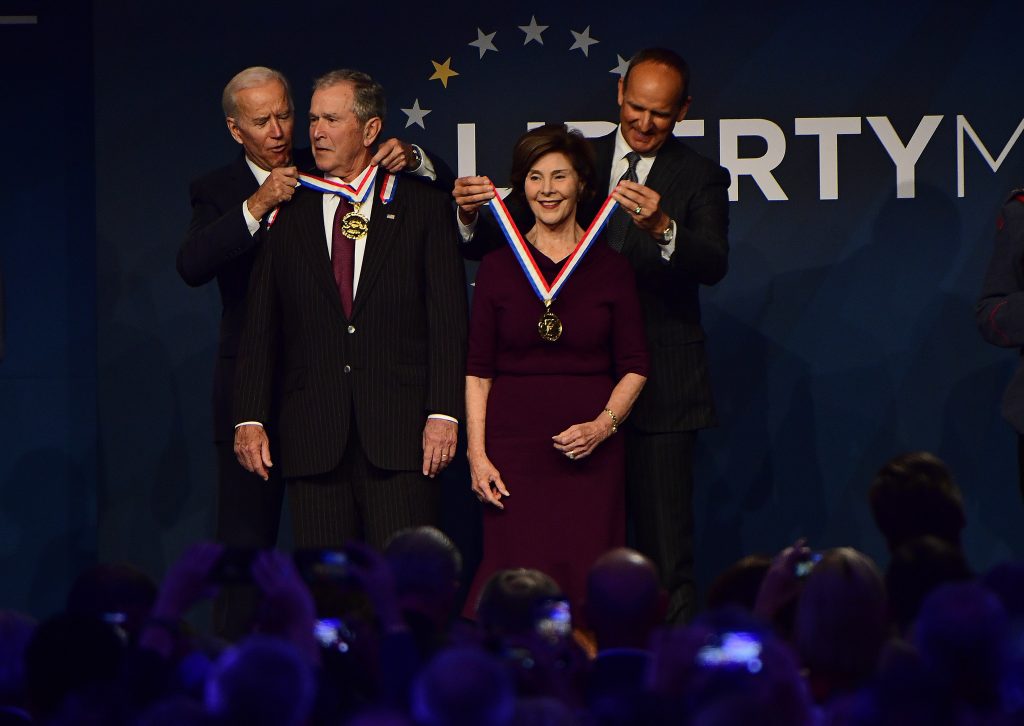 Liberty Medal Bush Former U.S. Vice President Joe Biden, from left, bestows a medal on former U.S. President George Bush as former first lady Laura Bush has the same bestowed by Doug DeVos, executive committee chairman for the National Constitution Center, at the National Constitution Center, Sunday, Nov. 11, 2018 in Philadelphia. Both received the 30th annual Liberty Medal, an honor given to those who are committed to freedom and human rights globally. (AP Photo/Corey Perrine)