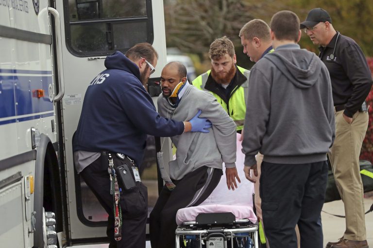 A man is helped onto a stretcher by emergency personnel after a car crashed into a Social Security office, Tuesday, Nov. 13, 2018 in Egg Harbor, N.J. Police say the driver was attempting to park when the car crashed into the building, entering a lobby where many people were waiting. It wasn't immediately clear how serious the injuries were. (Craig Matthews/The Press of Atlantic City via AP)