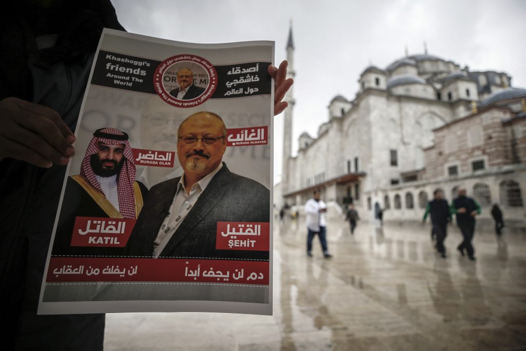 Turkey Saudi Arabia Writer Killed A man holds a poster showing images of Saudi Crown Prince Muhammed bin Salman and of journalist writer Jamal Khashoggi, describing the prince as