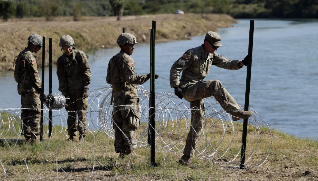 Migrant Caravan Troops Members of the U.S. military install multiple tiers of concertina wire along the banks of the Rio Grande near the Juarez-Lincoln Bridge at the U.S.-Mexico border, Friday, Nov. 16, 2018, in Laredo, Texas. (AP Photo/Eric Gay)